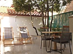 a group of chairs and a table in a patio at Menego Lodge Bol in Bol