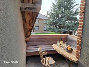 a table on a balcony with a bottle of wine at Duo La belle échappée & Romance in Poperinge