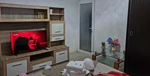 a living room with a flat screen tv on a entertainment center at Mazepa 2 You in Galaţi