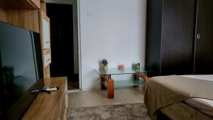 a bedroom with a bed and a glass table at Mazepa 2 You in Galaţi