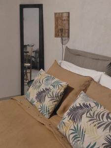 a bed with two pillows and a mirror in a room at B&b Villa Rosalia in Procida