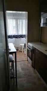 a small kitchen with a table and a window at Mazepa 2 You in Galaţi +7 photos