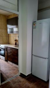 a kitchen with a white refrigerator in a room at Mazepa 2 You in Galaţi