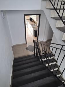 a staircase leading to the kitchen in a house at Pensjonat nad Stawem in Sarbinowo