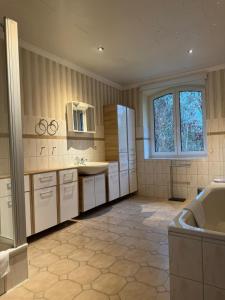 a large kitchen with white cabinets and a sink at Haus Groß Flöte in Wismar +49 photos