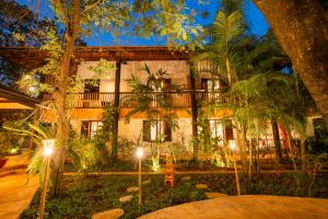 a building with trees and lights in front of it at Kampung Kamboja in Phum Pobos