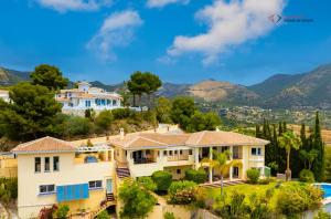 a house on a hill with mountains in the background at Diamante Villa Mijas in Mijas