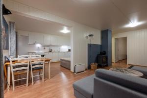 a living room with a dining table and a kitchen at Free EV Charging with Snacks and View in Blesom