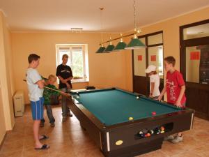 a group of people standing around a pool table at Rustical deluxe - Hexenhäuschen in Echternacherbrück