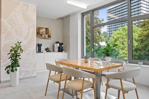 a kitchen and dining room with a wooden table and chairs at St. Joseph Royal Regent in Karlovy Vary