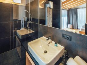 a bathroom with a sink and a mirror at Haus Piz Lad in Nauders +98 photos