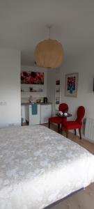 a bedroom with a bed and two red chairs at The Snug in Naas