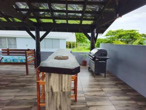 a outdoor kitchen with a table and a grill at The Golfing Shepherd in Mba +5 photos
