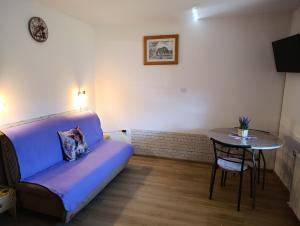a living room with a couch and a table at Apartmaji Verica Ceklin in Bohinj