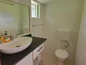 a bathroom with a sink and a toilet and a mirror at The Golfing Shepherd in Mba