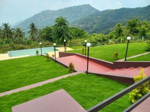 a view of a park with mountains in the background at WHITE FLOWER mountain resort in Perintalmanna
