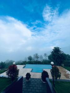 a view of a swimming pool in a yard at WHITE FLOWER mountain resort in Perintalmanna