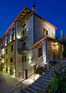 a building with stairs leading up to it at night at Xenonas Iresioni in Arachova