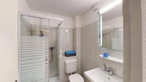 a bathroom with a shower and a toilet and a sink at Hotel Landhaus in Eschweiler +11 photos