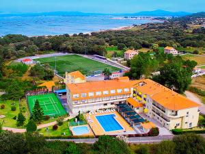 an aerial view of a building with a pool and a soccer field at Hotel Mar del Norte 3000 in O Grove