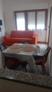 a living room with a table and a couch at A Casa Di Mina in Civitavecchia +2 photos