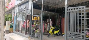 a yellow scooter parked outside of a store at LUNA House in Phú Vang