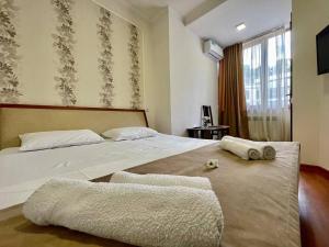 a bedroom with a bed with two towels on it at Merien hotel in Yerevan