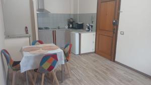 a kitchen with a table and chairs and a kitchen with a counter at A Casa Di Mina in Civitavecchia