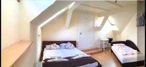 a bedroom with a bed and a table in a attic at Garden House in Budapest