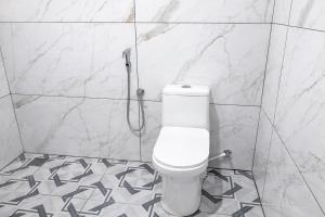 a bathroom with a toilet and a shower at LASplore munnar in Kallar Vattiyar