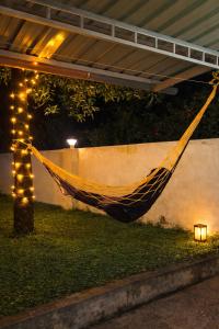 a hammock in a yard with a string of lights at LASplore munnar in Kallar Vattiyar +1 photo