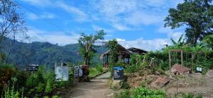 a small house on a hill with a dirt road at Cindrella Sky Nest Camp Ella in Ella