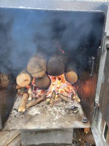a grill with pots and pans on a fire at La Casa du Vau - Tiny House in Bussy-le-Grand