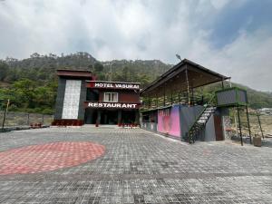 a building with a staircase in front of it at Hotel vasurai and restaurant in Nākuri