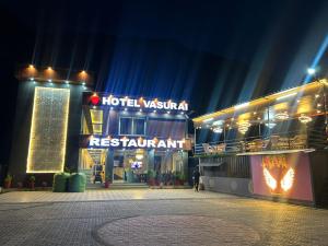a view of a hotel at night at Hotel vasurai and restaurant in Nākuri