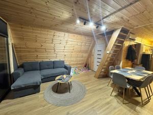 a living room with a blue couch and a table at 3A-CHALET-LIBaN in Liban