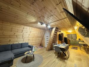 a living room with a blue couch and a wooden ceiling at 3A-CHALET-LIBaN in Liban