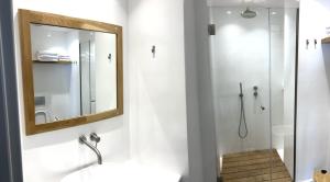 a bathroom with a shower and a mirror at Mercato Vecchio Guesthouse in Hydra +5 photos