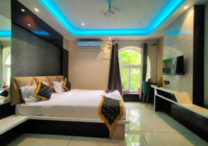 a bedroom with a large bed with a blue ceiling at Hotel Heritage Inn in Balasore +35 photos