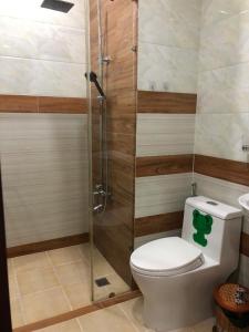 a bathroom with a toilet and a glass shower at namhan in Phú Quốc