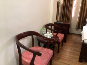 a dining room with two chairs and a table at namhan in Phú Quốc
