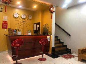 a lobby with two red chairs and a counter at namhan in Phú Quốc