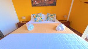 a bedroom with a bed with two slippers on it at La Costa del Pavone in Carini