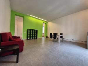 a living room with a red couch and a table at Casa Bon in Marigliano