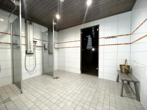a bathroom with a shower and a black door at Riihen Ullakko in Äkäslompolo