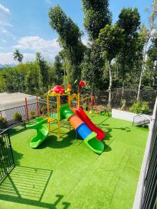 a playground with a slide on the grass at West wind Resort in Meppādi