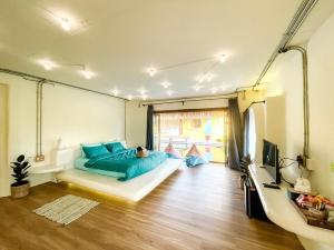 a bedroom with a bed with blue pillows at Sibsansmuth Resort in Ko Larn