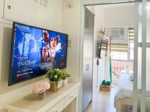 a living room with a flat screen tv on a wall at Little Treasure Tagaytay-Flora in Tagaytay