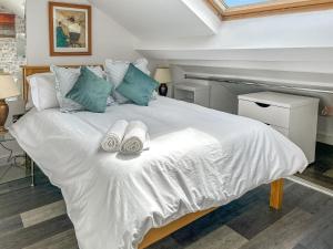 a bedroom with a white bed with towels on it at Holly's Apartment in Beverley
