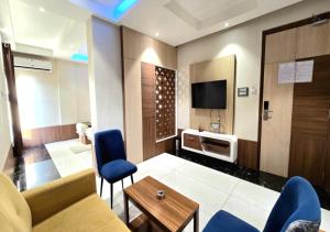 a living room with a couch and a tv at Hotel Heritage Inn in Balasore